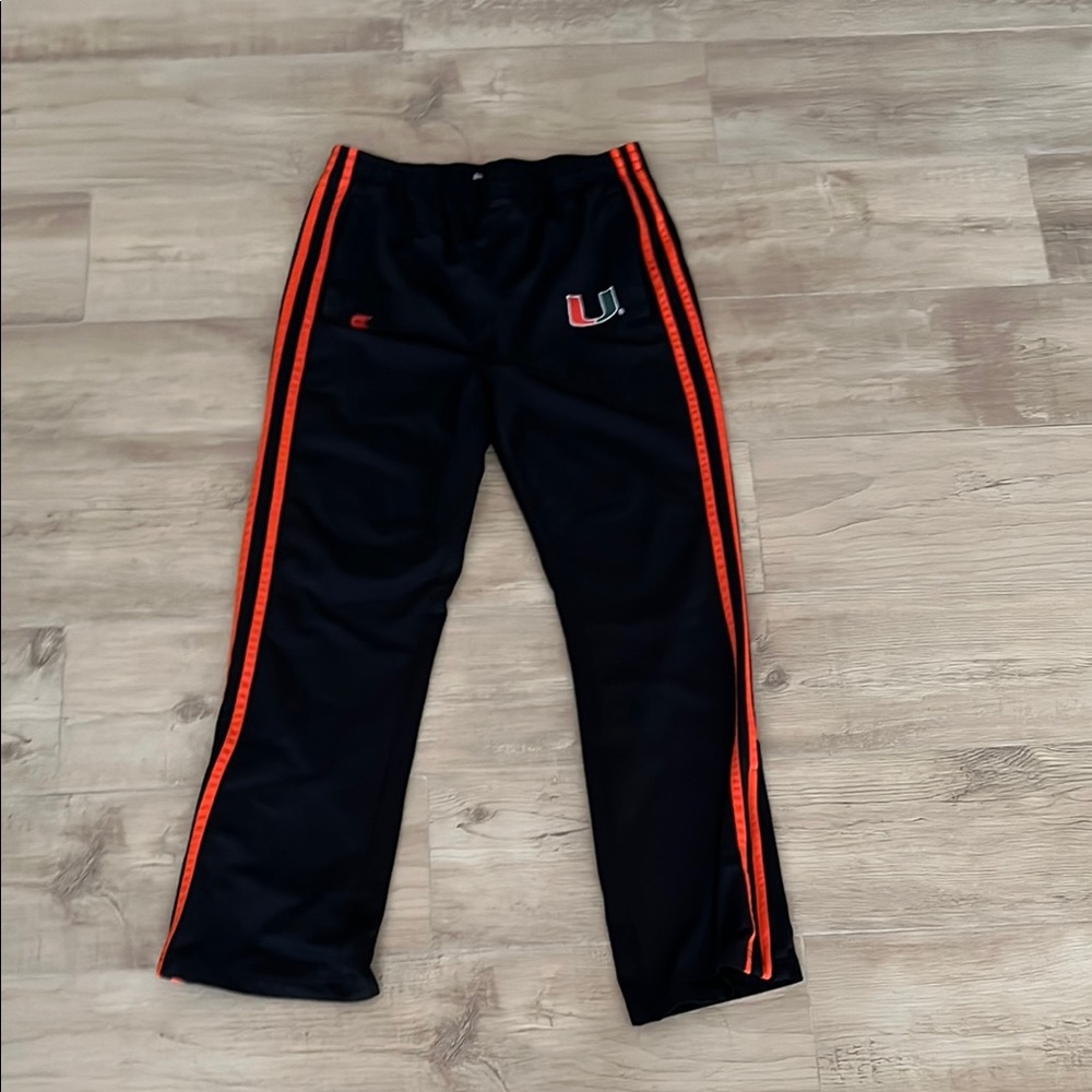 Colosseum brand Men’s UM Pants Black and Orange Track Pants with side zippers.